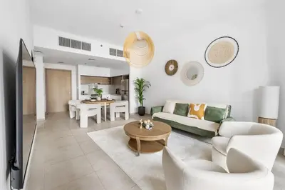 a living room with a couch and a table at Luxurious 1BR Modern Apartment Balcony Pool in Dubai