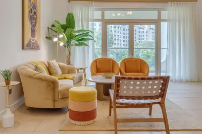a living room with two chairs and a table at Al Sarrood, Palm Jumeirah - 1 Bedroom Apartment - Allsopp & Allsopp in Dubai
