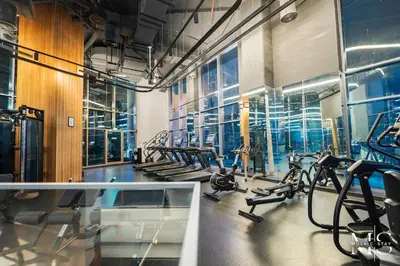 a gym with treadmills and elliptical machines at Luxury High Floor 1BHK Burj and Canal Views in Dubai