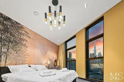 a bedroom with two beds and a large window at Luxury High Floor 1BHK Burj and Canal Views in Dubai