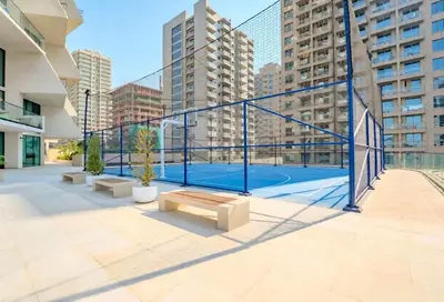 a tennis court in a city with tall buildings at TRPS - Binghatti Royale, JVC - Private Pool, Luxury Furnished, Brand New in Dubai