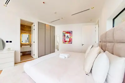 a white bedroom with a large bed with white pillows at Vacationer l Magnificent 4 Bedroom l Penthouse l Marina Views in Dubai