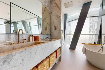 a bathroom with a tub and a large mirror at Vacationer l Magnificent 4 Bedroom l Penthouse l Marina Views in Dubai