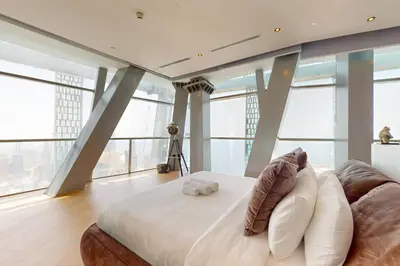a bedroom with a large bed with pillows at Vacationer l Magnificent 4 Bedroom l Penthouse l Marina Views in Dubai