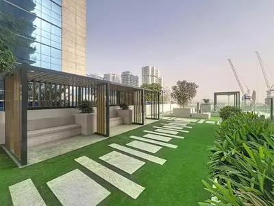 a rendering of a building with green grass at Vacationer l 1 Bedroom in Business Bay l Direct Pool Access in Dubai