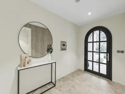 a room with a mirror and a table and a window at Redwood Townhouse Jumeirah Golf Estates in Dubai