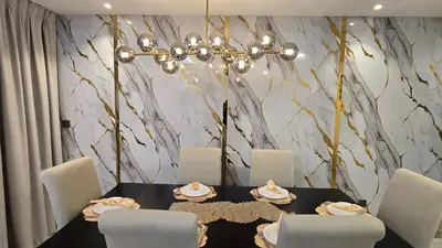 a dining room with a table with chairs and a chandelier at Beach, Palm Jumeirah & Marina view in Dubai