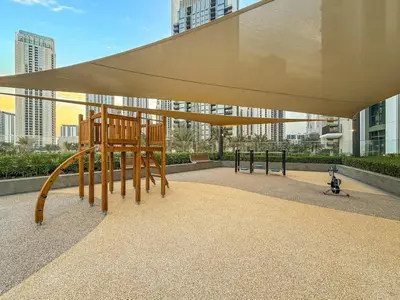 a playground with a large canopy in front of a building at FIRST CLASS 1BR Creek Escape & Modern Elegance in Dubai