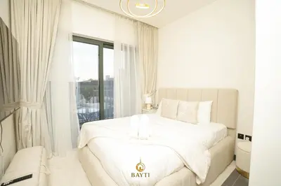 a white bedroom with a bed and a window at Evasion de luxe avec vue piscine, billard et lounge, à 15 minutes burj khalifa in Dubai