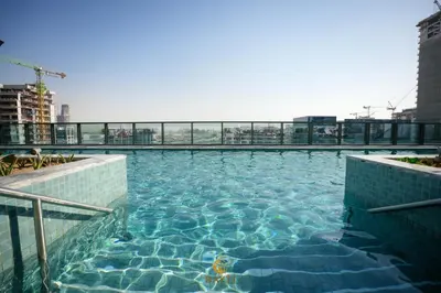 a swimming pool on the top of a building at Evasion de luxe avec vue piscine, billard et lounge, à 15 minutes burj khalifa in Dubai