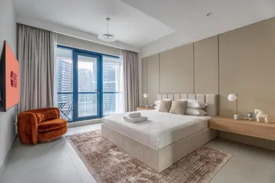 a bedroom with a large bed and a large window at GuestReady - 1BR | Elegant Duplex | JLT in Dubai