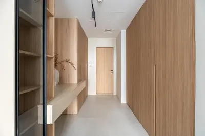 a hallway with wooden cabinets and a door at GuestReady - 1BR | Elegant Duplex | JLT in Dubai