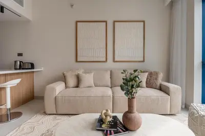 a living room with a couch and a table at GuestReady - 1BR | Elegant Duplex | JLT in Dubai
