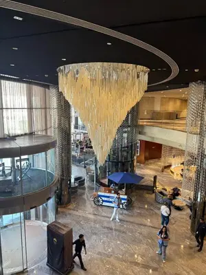 a large chandelier hanging from the ceiling of a building at Paramount Tower - Stylish 2BR Apartment with Balcony & Pool - Near Dubai Mall in Dubai
