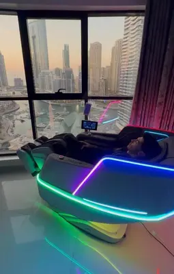 a person laying in a bed in a room with a window at Futuristic luxury apartment, 360 lake view balcony in Dubai
