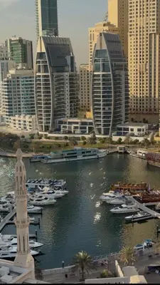 a group of boats in a harbor in a city at Futuristic luxury apartment, 360 lake view balcony in Dubai