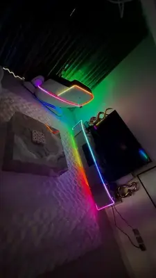 a bedroom with a bed with a rainbow light at Futuristic luxury apartment, 360 lake view balcony in Dubai