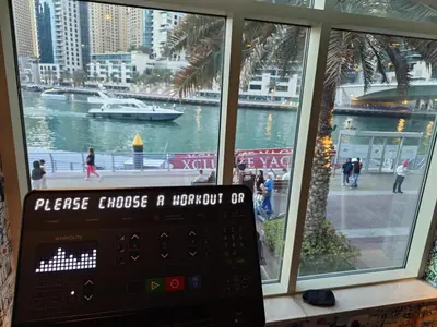 a window with a view of a river and a boat at 1 Bedroom in Dubai Marina Walk, Partial Water View in Dubai