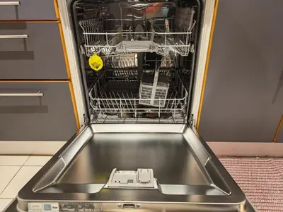 a dishwasher with its door open in a kitchen at 1 Bedroom in Dubai Marina Walk, Partial Water View in Dubai