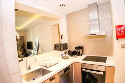 a small kitchen with a sink and a counter top at Newly Furnished Luxury 1BHK at Paramount Tower D in Dubai