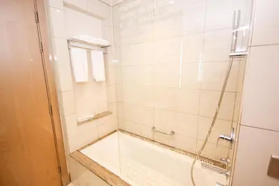 a bathroom with a shower with a glass door at Newly Furnished Luxury 1BHK at Paramount Tower D in Dubai