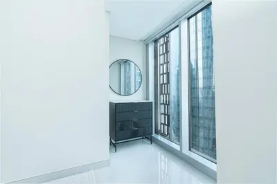 a hallway with a mirror and large windows at PVH - Refined 1BR in Marina - Cayan Tower in Dubai