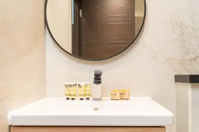 a bathroom with a white sink and a mirror at PVH - Refined 1BR in Marina - Cayan Tower in Dubai