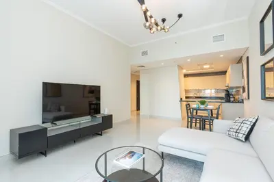 a living room with a couch and a table at PVH - Refined 1BR in Marina - Cayan Tower in Dubai