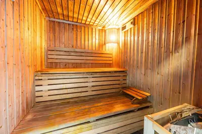 a wooden sauna with a wooden bench in it at StayShort - 1 Bed Apartment Sleeps 4 in Dubai Marina in Dubai
