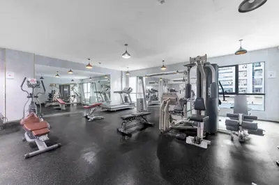 a gym with treadmills and machines in a room at StayShort - 1 Bed Apartment Sleeps 4 in Dubai Marina in Dubai