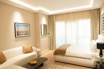 a hotel room with a bed and a couch at Chic studio located in the heart of Business Bay in Dubai