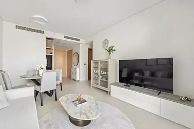 a living room with a large flat screen tv at Premium 2BR Burj Khalifa View at Vida Dubai Mall in Dubai