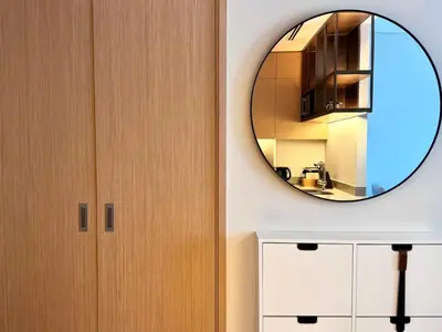 a bathroom with a mirror and a cabinet at Premium 2BR Burj Khalifa View at Vida Dubai Mall in Dubai