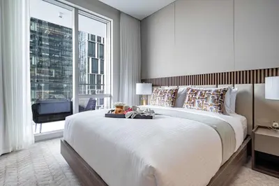 a bedroom with a large bed and a large window at Frank Porter - Vida Residences Dubai Mall in Dubai