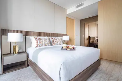 a bedroom with a large white bed with two lamps at Frank Porter - Vida Residences Dubai Mall in Dubai