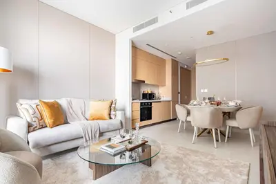 a living room with a couch and a table at Frank Porter - Vida Residences Dubai Mall in Dubai