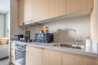 a kitchen with a sink and a microwave at Frank Porter - Vida Residences Dubai Mall in Dubai