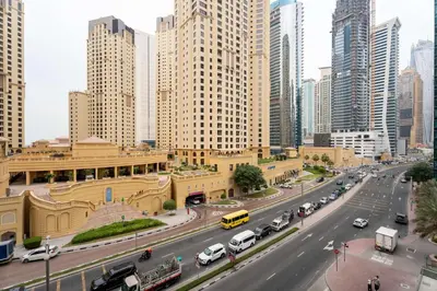 a busy city street with cars and buildings at Modern Marina Studio w City Views & King Bed in Dubai