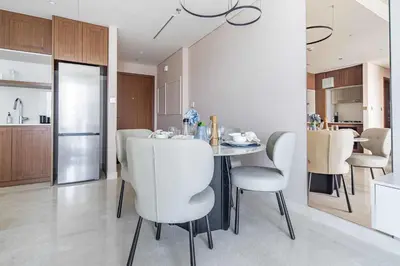 a kitchen and dining room with a table and chairs at Frank Porter - Palace Beach Residence in Dubai
