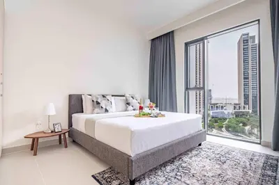 a bedroom with a large bed and a large window at Frank Porter - Island Park 2 in Dubai