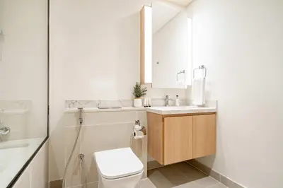 a bathroom with a toilet and a sink and a shower at Frank Porter - Island Park 2 in Dubai