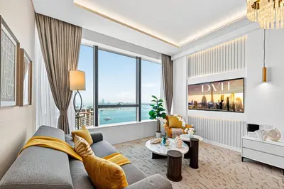 a living room with a couch and a large window at DVH Luxe Retreats at The Palm Tower, Palm Jumeirah, Studio Apartment in Dubai