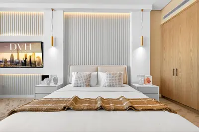 a bedroom with a large white bed with two pillows at DVH Luxe Retreats at The Palm Tower, Palm Jumeirah, Studio Apartment in Dubai