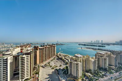an aerial view of a city with a river and buildings at DVH Luxe Retreats at The Palm Tower, Palm Jumeirah, Studio Apartment in Dubai