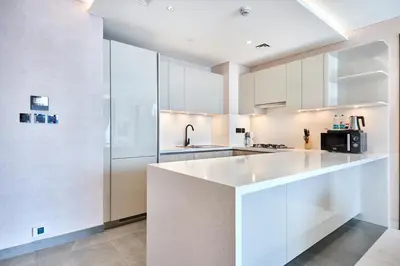 a kitchen with white cabinets and a counter top at STAY BY LATINEM Luxury 3BR Holiday Home CA 0702 Near Burj Khalifa in Dubai