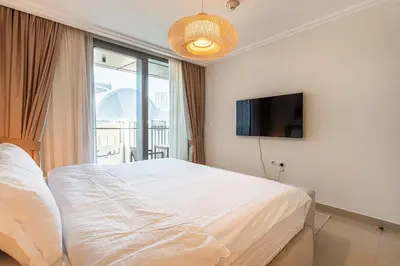 a bedroom with a bed and a flat screen tv at Burj khalifa view I Sofa bed I walking distance to Dubai Mall in Dubai