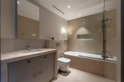 a bathroom with a toilet and a shower and a sink at Burj khalifa view I Sofa bed I walking distance to Dubai Mall in Dubai
