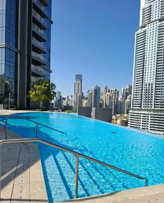 a large swimming pool on the roof of a building at Burj khalifa view I Sofa bed I walking distance to Dubai Mall in Dubai