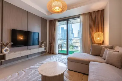 a living room with a couch and a tv at Burj khalifa view I Sofa bed I walking distance to Dubai Mall in Dubai