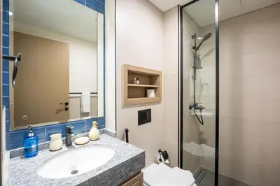 a bathroom with a sink and a shower at Santorini Damac Lagoons Luxury 3BR Villa Mediterrean Bliss in Dubai